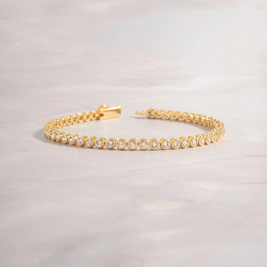 Gold bezel tennis bracelet 6.75”